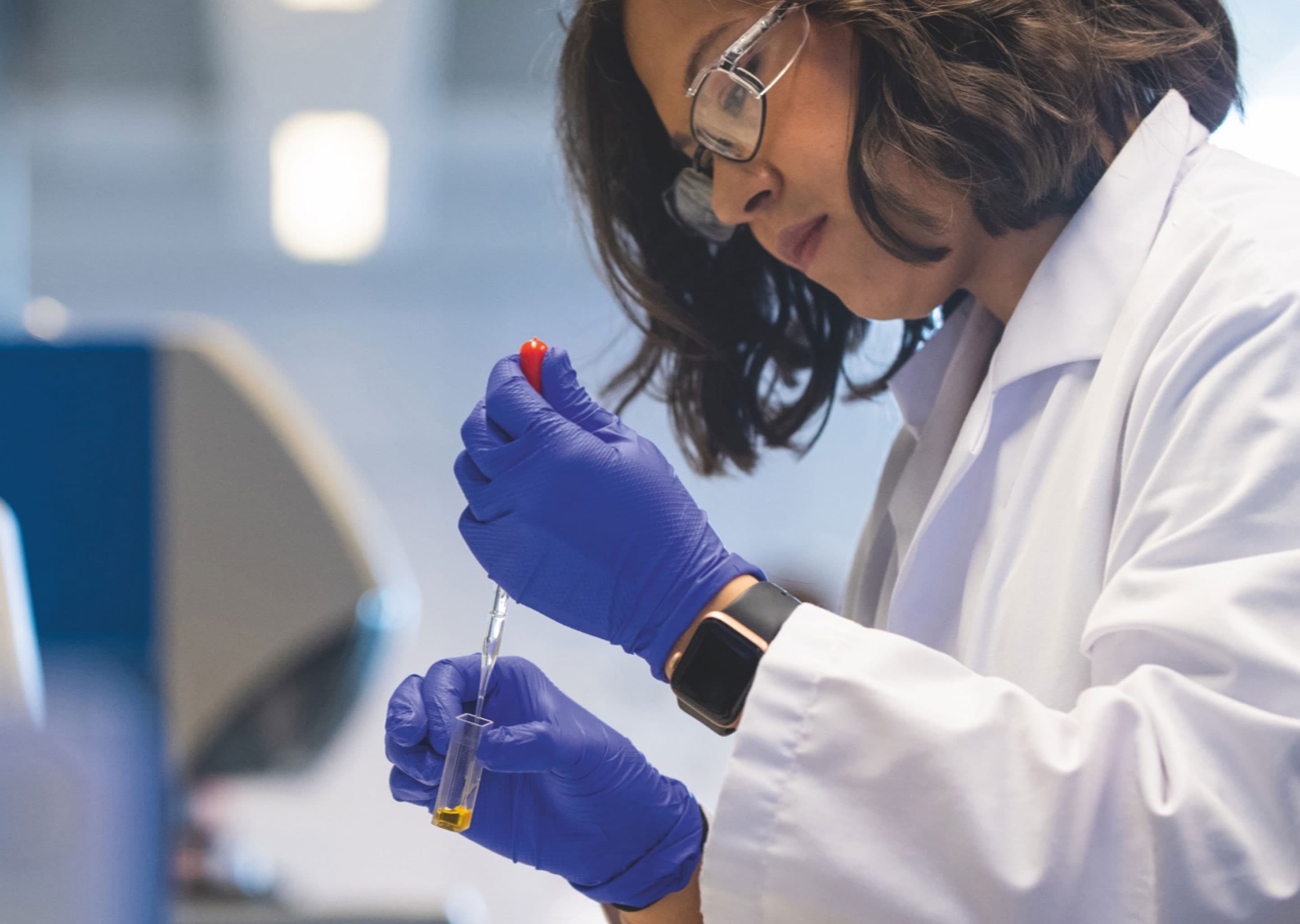 a female scientist with a pipet and test tube
